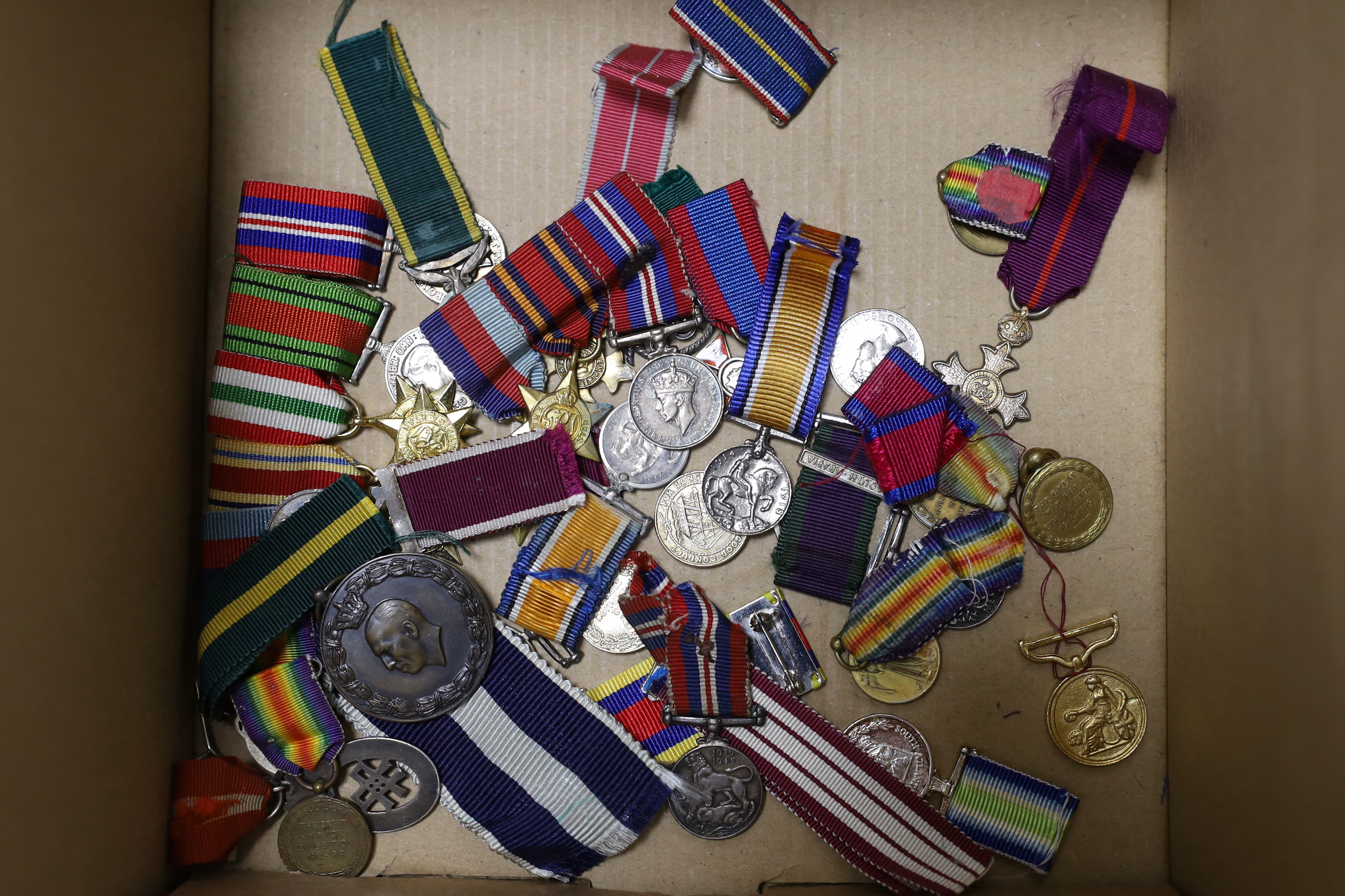 A collection of mainly British medals, awards and associated items including; six coronation medals for ERII, GRVI and GRV, three Victory Medals and a 1914-15 Star, a good selection of WWI and later miniatures including